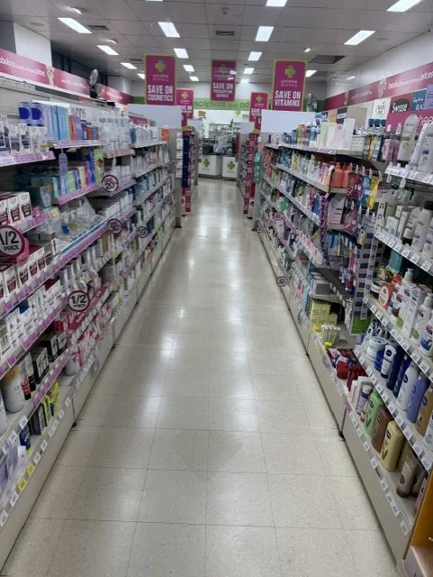 Pharmacy aisle with vitamins, personal care and skincare products